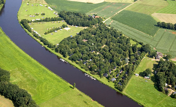 Aerial view of a canal and green fields in Holland/