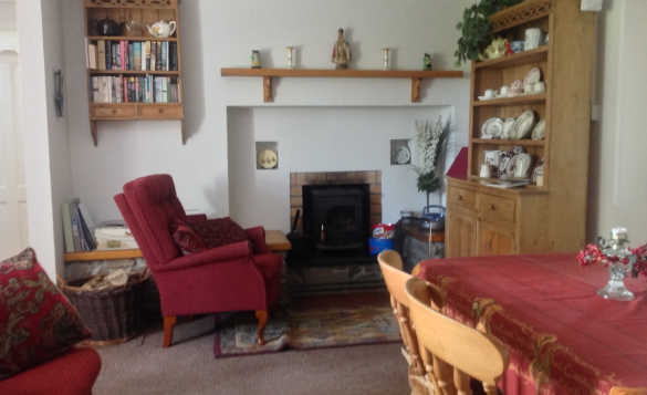 Lounge at Lackaroe self-catering with chairs arranged around an open fire/