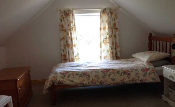Bedroom at Lackaroe self-catering cottage with pine single bed by a window/