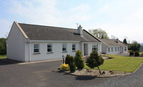 Two white single storey cottages in Ireland/
