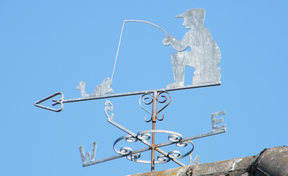 Weather vane with a man catching a fish/
