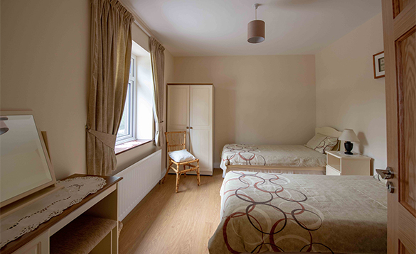 Bedroom with two double beds at the Arches self-catering cottage, Arva/