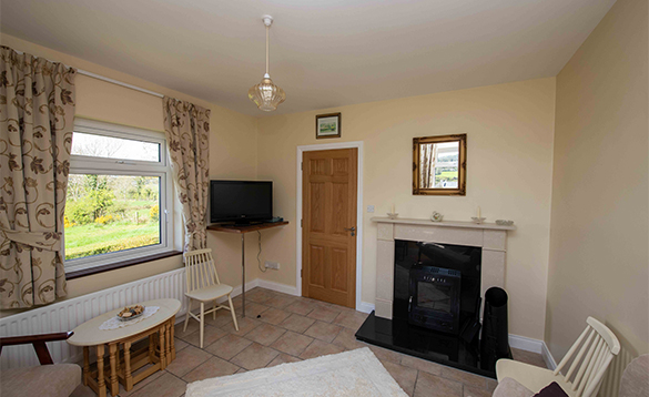 Lounge with open fire at the Arches self-catering cottage in Arva/