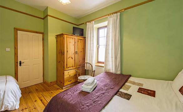 Bedroom with double and single bed at O'Callaghan's Bar, Coachford/