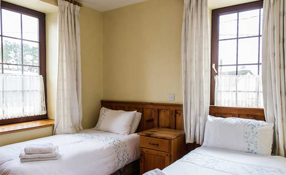 Bedroom at O'Callaghan's Bar with two single beds/