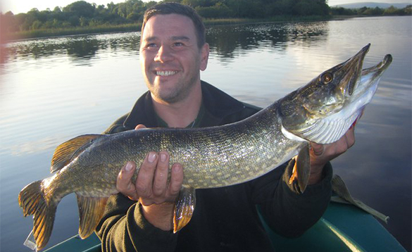 Angler holding a large pike/