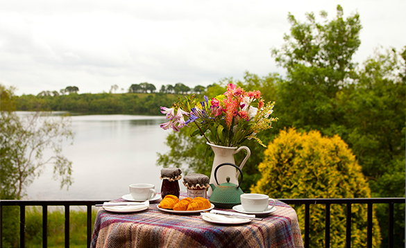 Table set for breakfast on a balcony with views over Lough Erne/