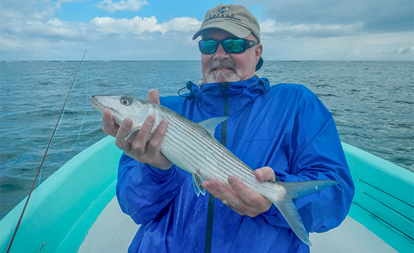 Angler holding a bonefish caught in Belize/