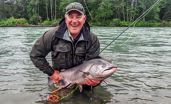 Angler holding a recently caught salmon in Canada/
