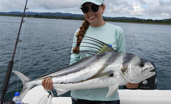 Lady angler holding a rooster fish caught in Costa Rica/