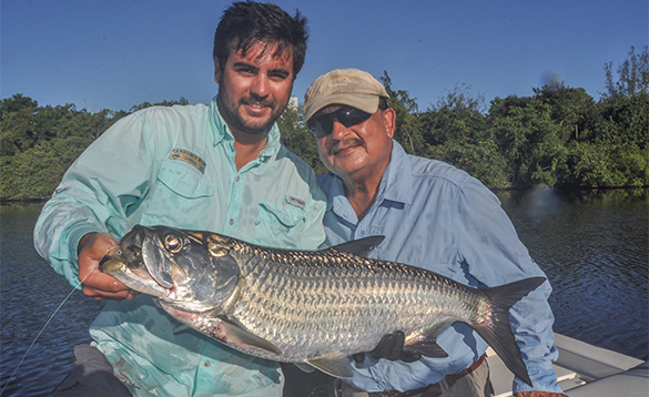 Two anglers holding a tarpon caught in Puerto Rico/