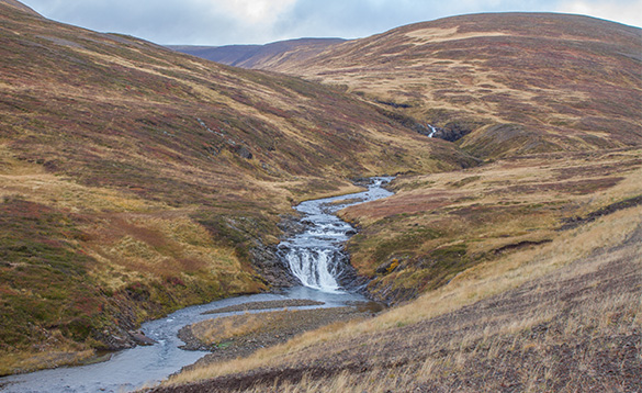 River flowing between hills in Iceland/
