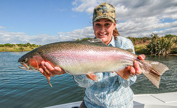 guide with a big rainbow trout from Big O lake/