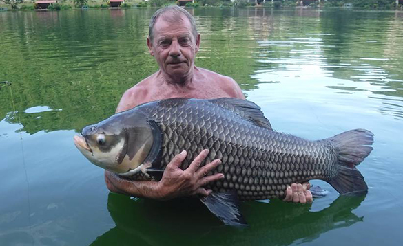 Angler holding a carp caught in Thailand/