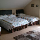 Bedroom with double and two single beds