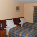 Hotel bedroom with three single beds