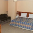 Hotel bedroom with double bed and settee
