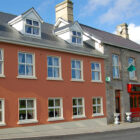 Stone two storey building with red entrance