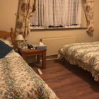 Double bed and single bed with flower patterned quilts