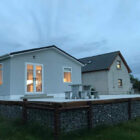 White bungalow with seating on decked area
