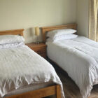 Two single beds with white quilts