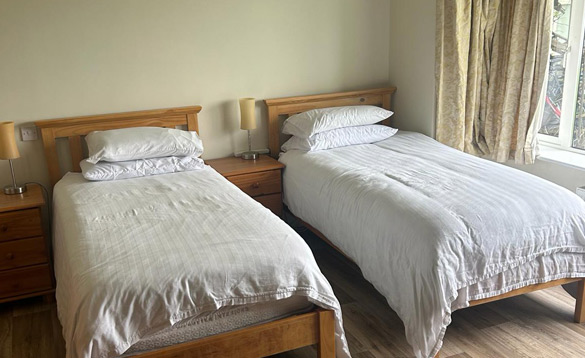 Two single beds with white quilts
