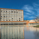 Eight storey hotel block reflected in a lake