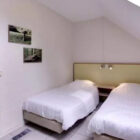 Bedroom with two single beds with white bed linen
