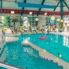 Large swimming pool with multicoloured bunting and red float in the pool