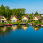 Six dorma bungalows around a large lake with boat moored around the lake