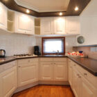 Compact cream kitchen with dark wooden counter tops