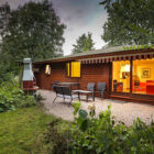 Log cabin style chalet with brick paved patio with table and chairs on