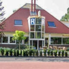 Single storey building with large sloping roof and glass entrance