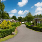 Road leading through a holiday park with chalets either side