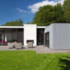 single storey building with paved area and rattan garden furniture