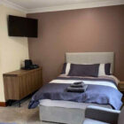 Hotel bedroom with double bed with white and blue bed linen