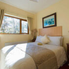 Bedroom with double bed and light on a bedside cabinet
