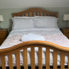 Bedroom with pine double bed and two pine bedside cabinets