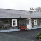 Single storey stone built cottage with slate roof