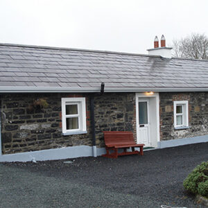 Single storey stone built cottage with slate roof