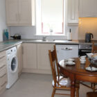 Compact kitchen with wood dining table set for breakfast