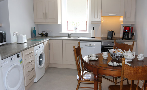 Compact kitchen with wood dining table set for breakfast