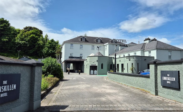 Ireland Fishing Holidays Enniskillen Hotel (7) A wide-angle exterior view of the Enniskillen Hotel, showing the main entrance, "Becketts" signage, and a paved driveway under a blue sky.