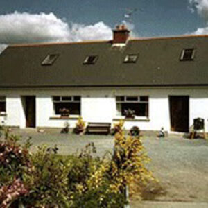 White bungalow with sloping grey slate roof