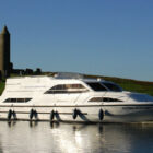 Cruiser navigating along a river bank in Ireland