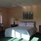 Sun light shining through a window onto a double bed