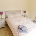 Bedroom with double bed and two bedside cabinets with lamps