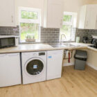 Laundry room with cream units and grey tiles