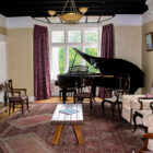 Chairs arranged around a room with a grand paino in a corner near a window