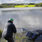 Angler landing a fish caught on a lake in Ireland